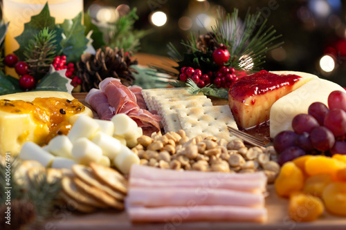 Board with Grape, Cookie, Jam, Bread, Peanut, Tangerine, Ham, Candle, Pine Cone, Cheese to eat at Christmas