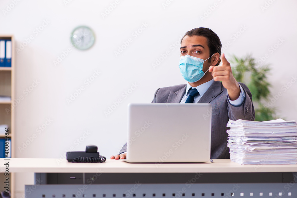 Young male employee wearing mask during pandemic Young male employee wearing mask during pandemic