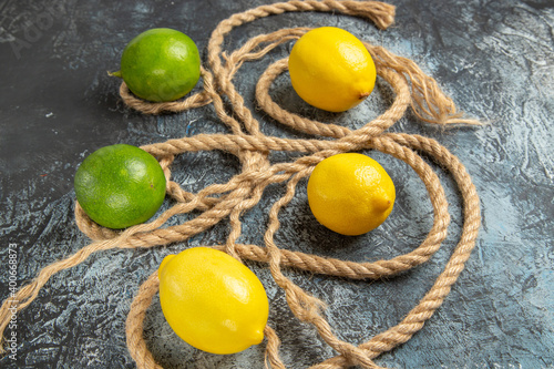 front view fresh lemons with ropes on light-dark background fruit citrus photo colors