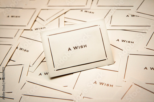 Cards with the words A Wish written on them in a sacattrered patern on a table photo