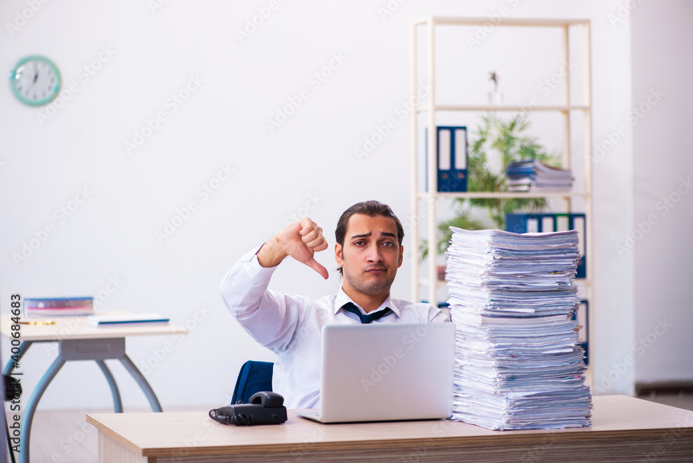 Naklejka premium Young male employee unhappy with excessive work