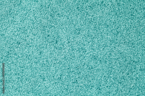Blue fluffy background of soft, fleecy cloth. Texture of turquoise wool textile.