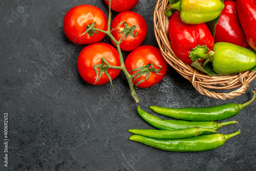 top view fresh bell-peppers with red tomatoes on a dark background food salad ripe photo