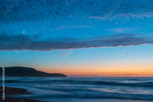 High cloud, partial moon and a pretty blue dawn at the beach