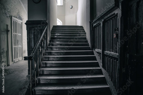 An ancient staircase in a beautiful abandoned manor house. The interior of an abandoned building. A mystical abandoned mansion.