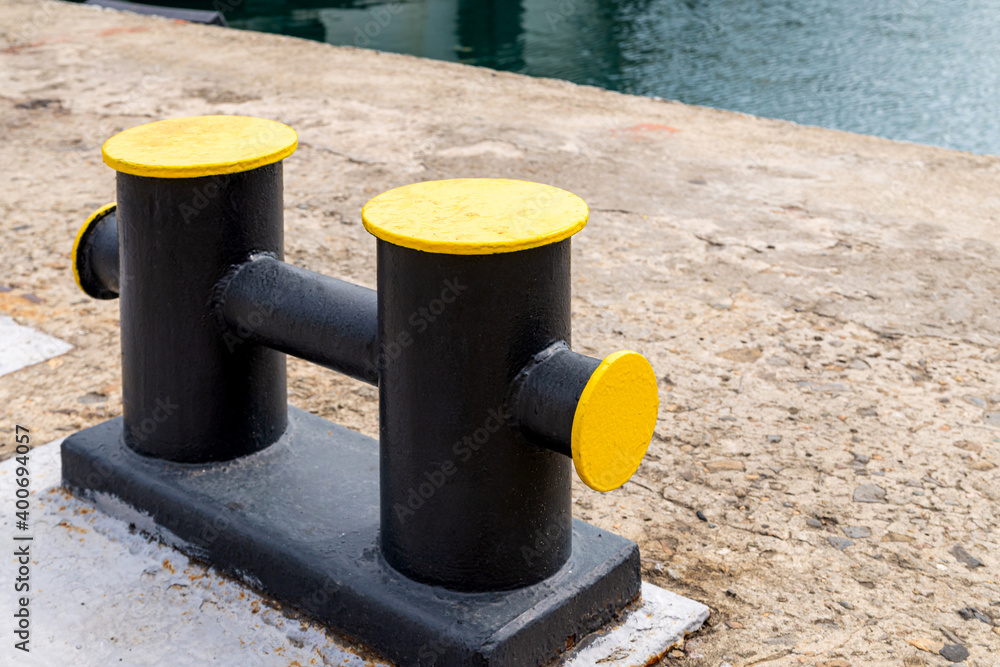 Mooring bollard on a wharf, to which a ship's rope may be secured Mooring bollard on a wharf, to which a ship's rope may be secured