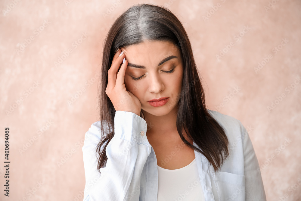 Stressed woman with graying hair on color background Stressed woman with graying hair on color background