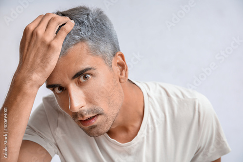 Stressed man with graying h...