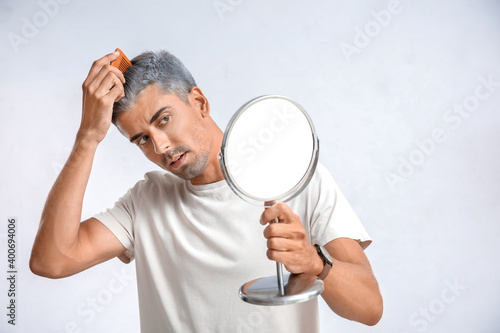 Man with graying hair looki...