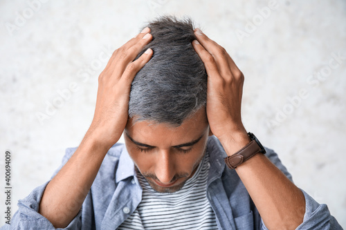 Stressed man with graying h...