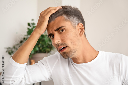 Stressed man with graying h...