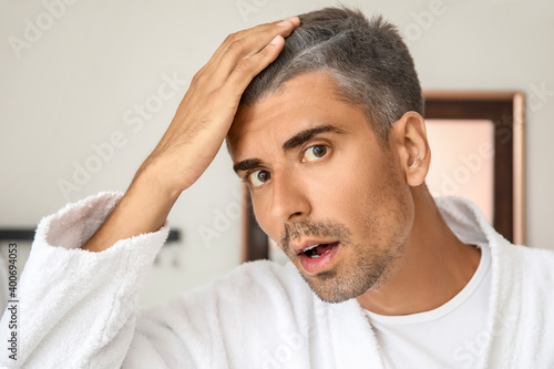 Stressed man with graying h...