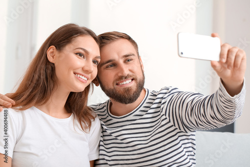 Young couple taking selfie ...
