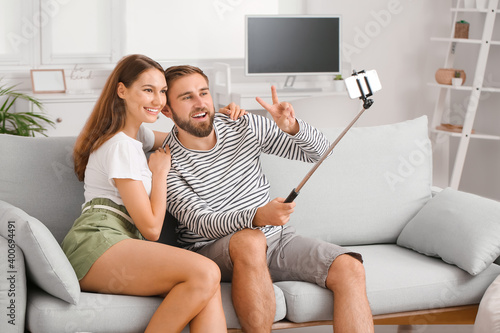 Young couple taking selfie ...