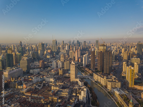 Photography Aerial view of the skyline in Puxi, Shanghai, at sunrise.