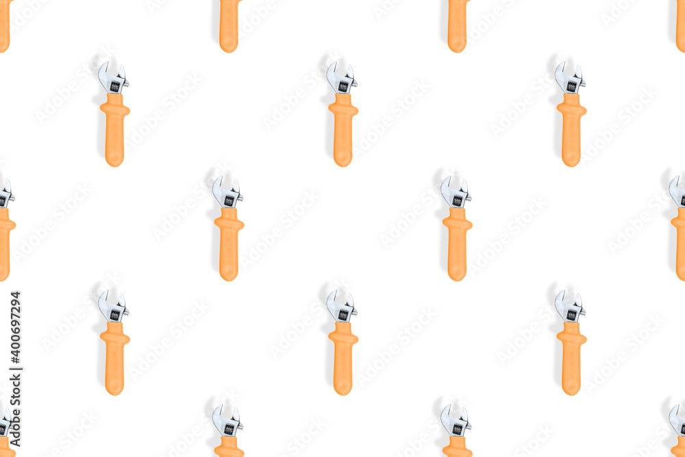 Wrench on a white background. Seamless background from adjustable metal wrench. Seamless patterns. Wrench on a white background. Seamless background from adjustable metal wrench. Seamless patterns.