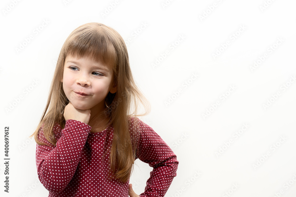 beautiful caucasian kid girl is planning something. sly look. layout with place for text, copy space beautiful caucasian kid girl is planning something. sly look. layout with place for text, copy space