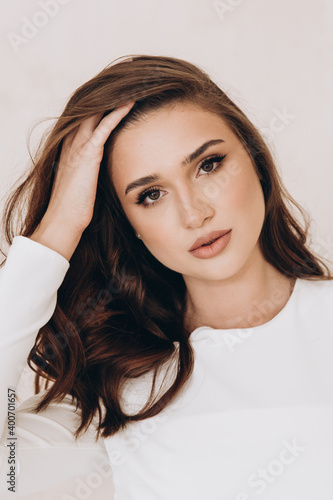 Beautiful girl in a dress on a fashion photoshoot in a photostudio