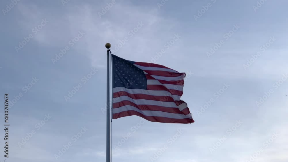 Torn American flag flying in the wind Torn American flag flying in the wind