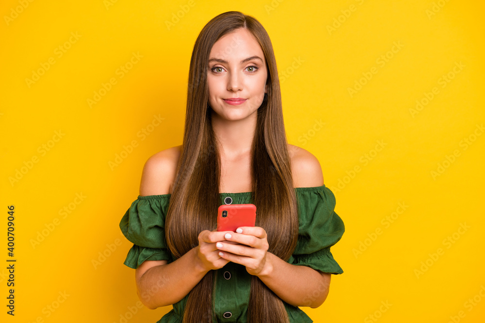 Portrait of pretty cheery long-haired girl using device smm leisure browsing web isolated over bright yellow color background