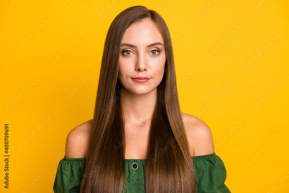 Close-up portrait of charming content brown-haired teenage girl isolated over vibrant yellow color background Close-up portrait of charming content brown-haired teenage girl isolated over vibrant yellow color background