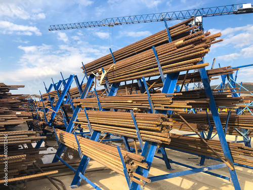 Metal reinforcement parts on metal racks at outdoor warehouse at construction site