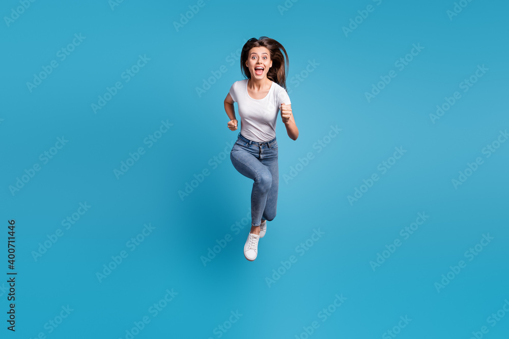 Full body photo of pretty crazy girl run you jump up air unbelievable sale isolated on blue color background