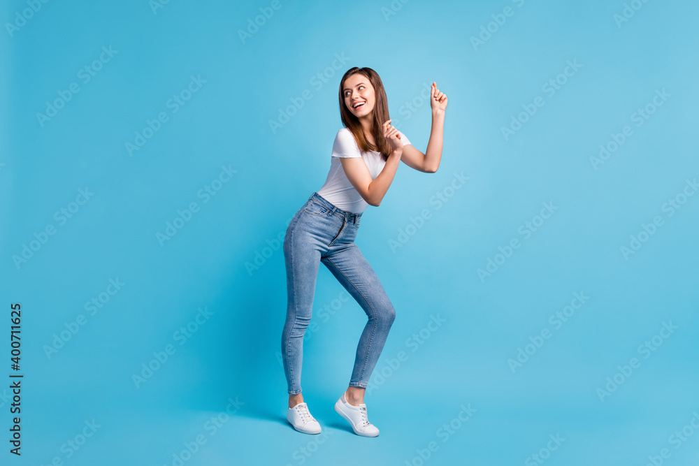 Full size profile side photo of dreamy cute lady look empty space dance funky isolated on blue color background