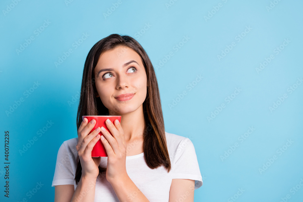 Photo of young dreamy lovely sweet cute attractive girl drink coffee look copyspace isolated on blue color background Photo of young dreamy lovely sweet cute attractive girl drink coffee look copyspace isolated on blue color background