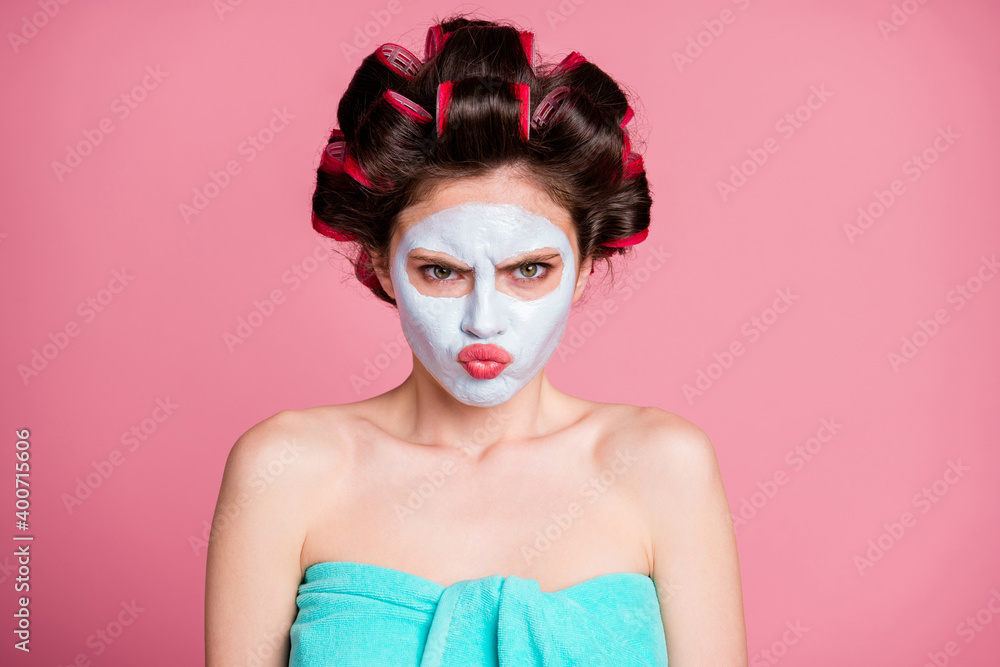 Close-up portrait of attractive mad grumpy sullen housewife wearing natural mask frowning isolated on pink pastel color background Close-up portrait of attractive mad grumpy sullen housewife wearing natural mask frowning isolated on pink pastel color background