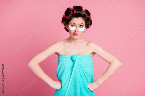 Photo of unsure girl with eye patches put hands waist look copyspace think wear towel isolated pastel color background