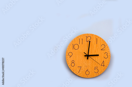 Wooden clock on the green wall