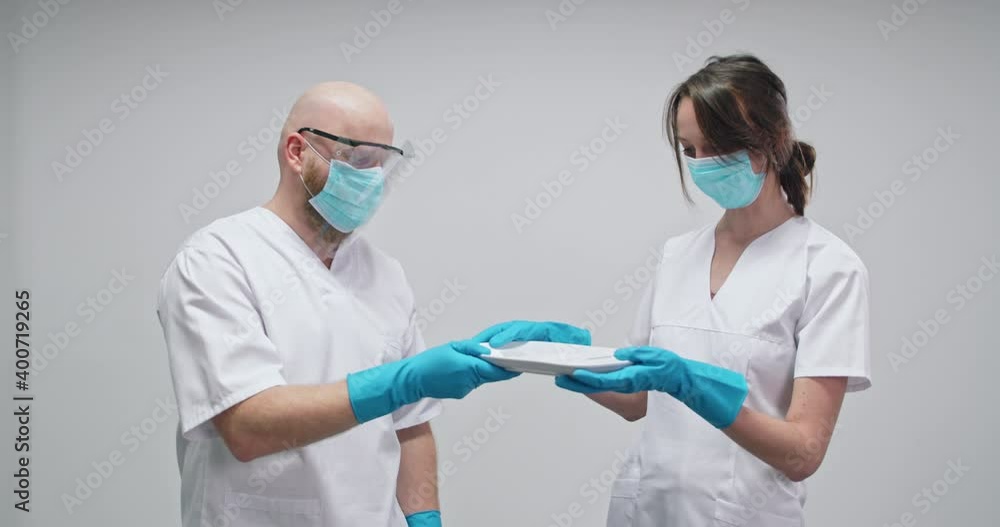 MS Doctor and nurse wearing protective face masks and gloves MS Doctor and nurse wearing protective face masks and gloves