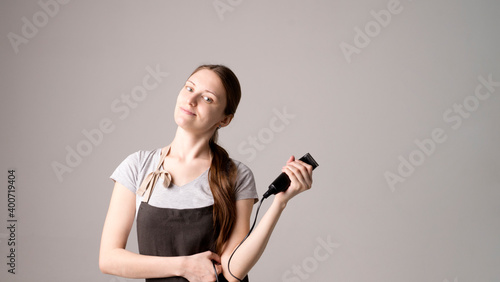 Attractive hairdresser woman with professional tools in her hands
