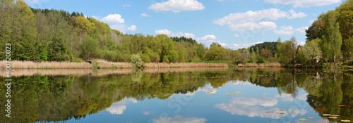 A typical spring rural Lithuanian panoramic landscape wuth a lake and forest