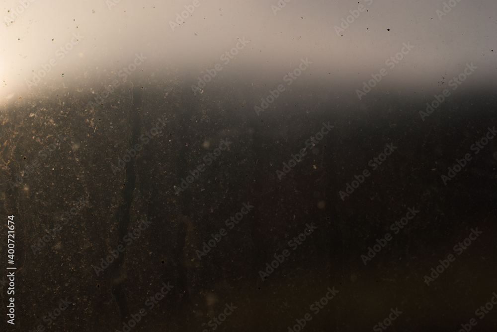Dirty environment concept. Abstract image of a mountain seen from behind a dirty window at dusk. Dirty environment concept. Abstract image of a mountain seen from behind a dirty window at dusk.
