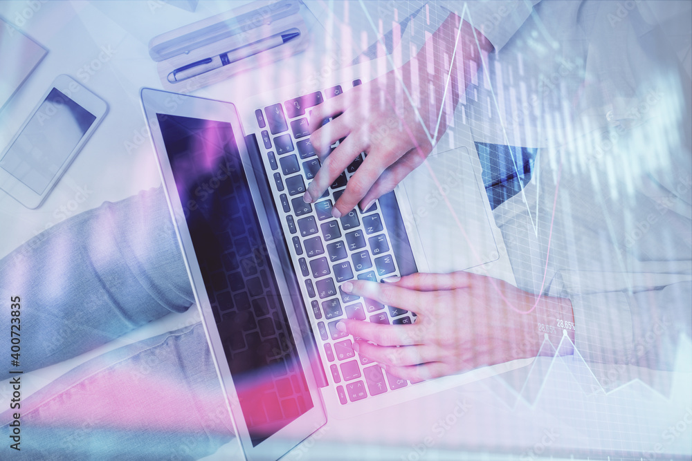 Double exposure of woman hands working on computer and forex graph hologram drawing. Top View. Financial analysis concept. Double exposure of woman hands working on computer and forex graph hologram drawing. Top View. Financial analysis concept.