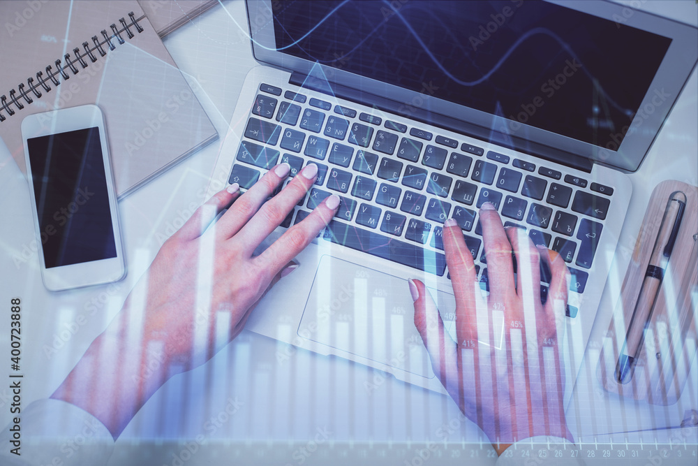 Double exposure of woman hands working on computer and forex graph hologram drawing. Top View. Financial analysis concept. Double exposure of woman hands working on computer and forex graph hologram drawing. Top View. Financial analysis concept.