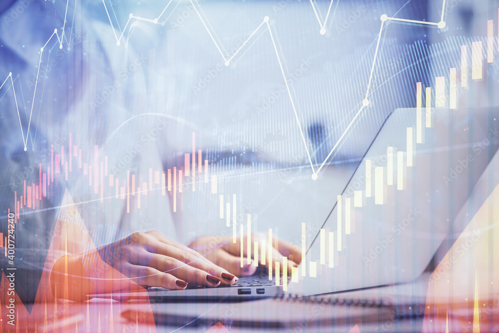 Double exposure of woman hands working on computer and forex graph hologram drawing. Financial analysis concept. Double exposure of woman hands working on computer and forex graph hologram drawing. Financial analysis concept.