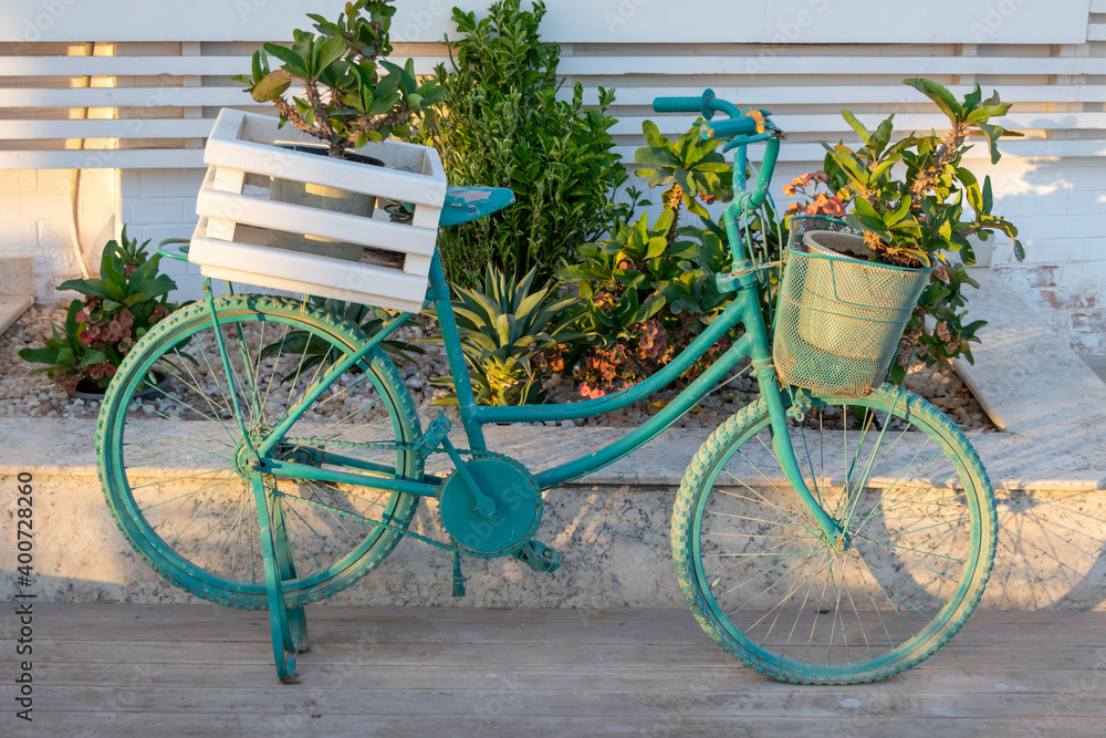 Old blue decorative bike with flowers - street or garden decoaration ideas
