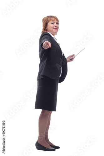 Profile view of aged woman holding tablet and looking at screen with satisfied face