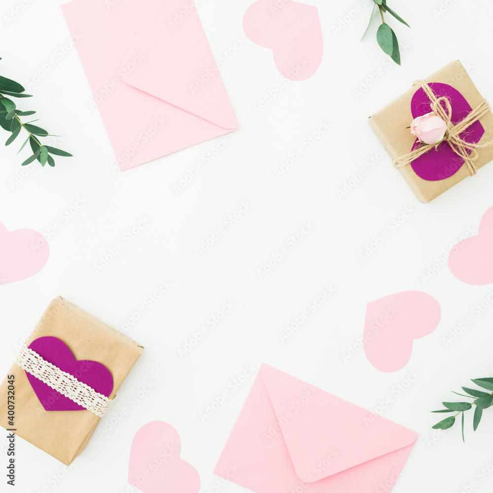 Valentines day. Frame with gifts, pink envelope and eucalyptus isolated on white background. Flat lay Valentines day. Frame with gifts, pink envelope and eucalyptus isolated on white background. Flat lay