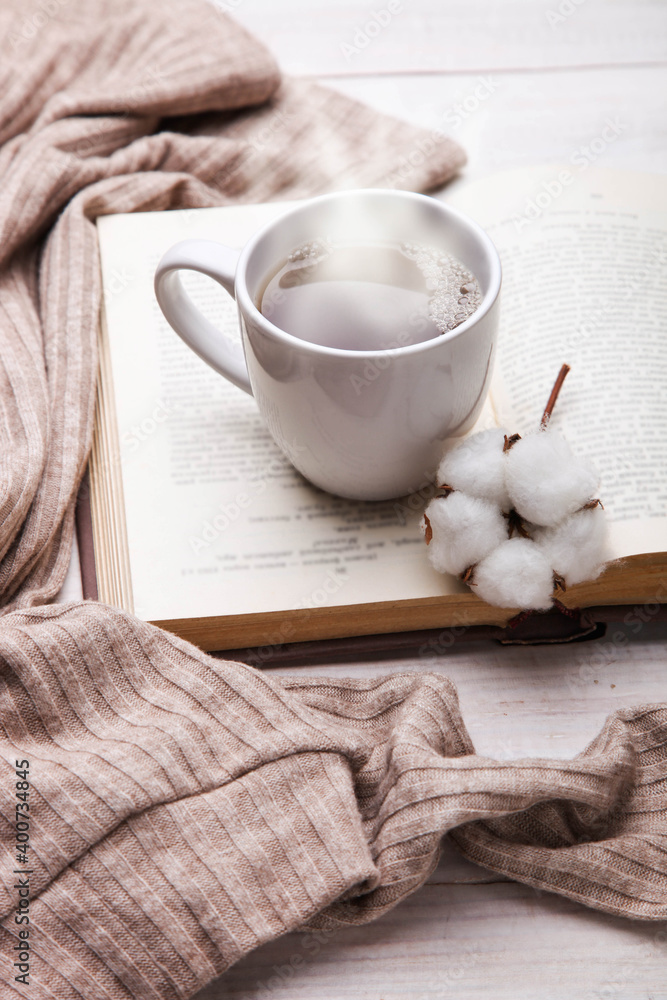 cup of hot tea and open book