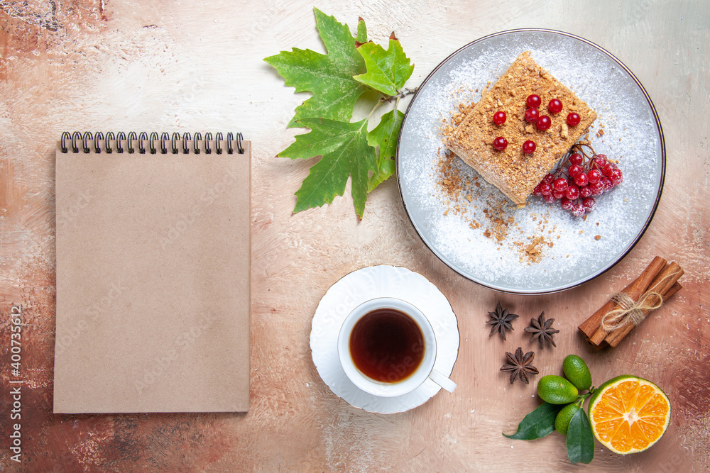 top view cake slice with tea and red berries on light desk cake biscuit sweet top view cake slice with tea and red berries on light desk cake biscuit sweet