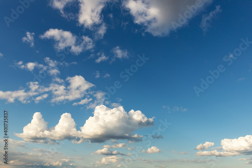 Weird unusual animal silhouette fantasy dream cloudscape on beautiful evening blue sky background. Fluffy cumulus cloud hills floating in clear skyline horizon. Natural sky panorama