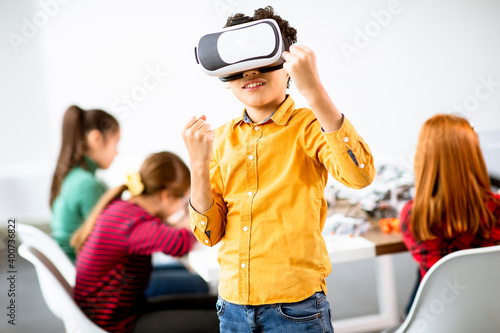 Cute little boy wearing VR virtual reality glasses