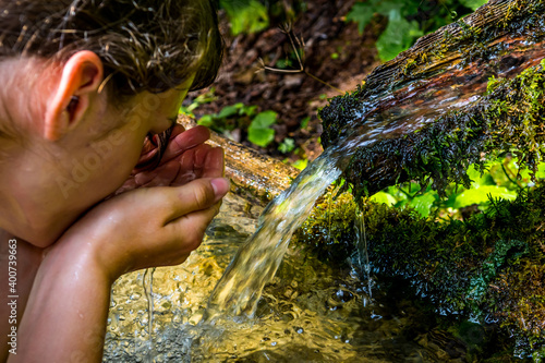 Fotografija Washing Hands And Drink From A Spring With Clear And Cold Mountain Water
