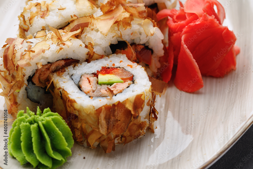 Sushi roll with tuna shavings on plate close up Sushi roll with tuna shavings on plate close up