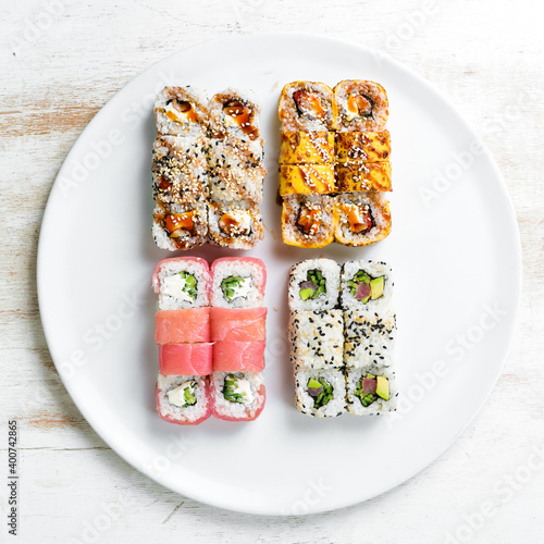Set: sushi rolls with eel, sesame, avocado and fish. Japanese food. Top view. On a white background.