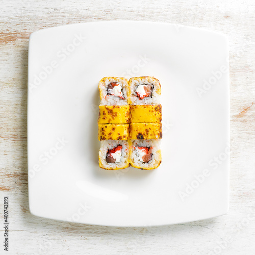 Traditional sushi rolls with cheese. Japanese food. Top view. On a white background.